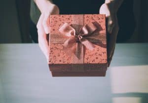 Female hands holding a gift box